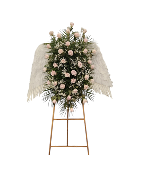 Sympathy standing spray featuring soft pink roses, baby’s breath, and angel wings arranged on an easel by Walter Knoll Florist.