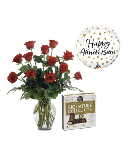 Dozen red roses in a glass vase, accompanied by an anniversary balloon and a 16-piece box of St. Louis chocolates, ideal for celebrating special milestones.