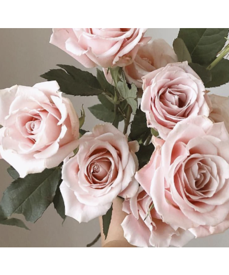 Elegant arrangement of white roses with eucalyptus in a clear glass vase, designed by Walter Knoll Florist for a timeless, simple yet luxurious floral display.