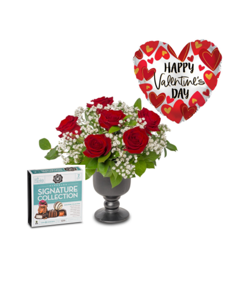 A dozen contemporary roses arranged beautifully, paired with a scented candle and a box of chocolates, creating a luxurious and romantic gift set.