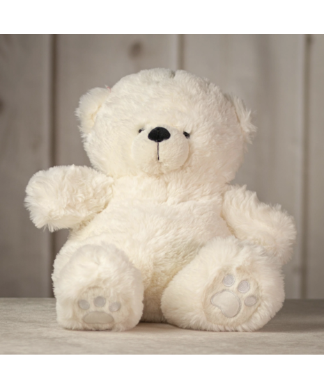 Four plush teddy bears in soft brown, grey, ivory, and light beige sitting on a surface, showcasing different colors of the cuddly Snuggle Bear Collection.