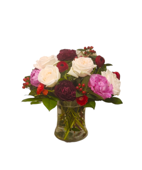 A luxurious bouquet of fragrant peonies, garden roses, and ranunculus in shades of pink, red, and blush, arranged beautifully for a romantic and elegant display.