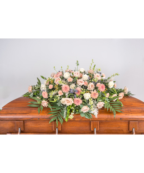 Elegant Pure Grace Casket Spray, a tranquil tribute with ivory, peaches, blues, and lush roses