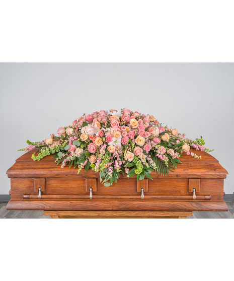 monochrome casket spray shown in pink color wave