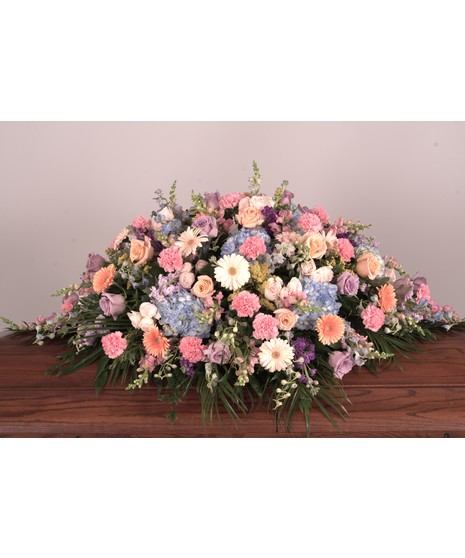 Pastel Beauty Casket Spray: A tranquil arrangement of lavender roses, blue hydrangeas, and delicate pastels for a serene farewell.