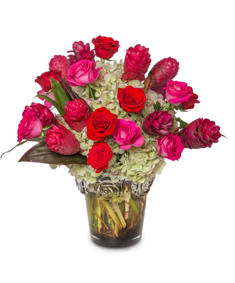 Grandiose Love floral arrangement with antique hydrangeas, red tropical gingers, pink and red roses, and tropical foliage in a high-end luxury vase.