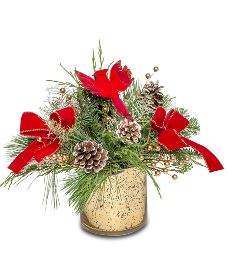 Holiday centerpiece with a red cardinal, pinecones, red velvet ribbon, gold berries, and winter greens in a gold vase