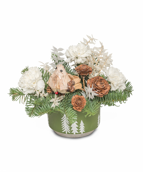 Green pot arrangement with white roses, carnations, wintergreens, pinecones, and an owl decoration