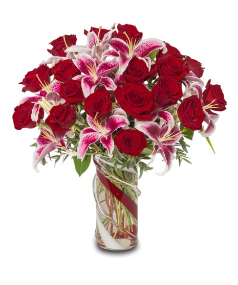 Lovestruck Lilies with Stargazer lilies, eucalyptus, and tropical greens in a red and clear heavy glass vase, designed for all-around viewing. Luxurious and elegant.