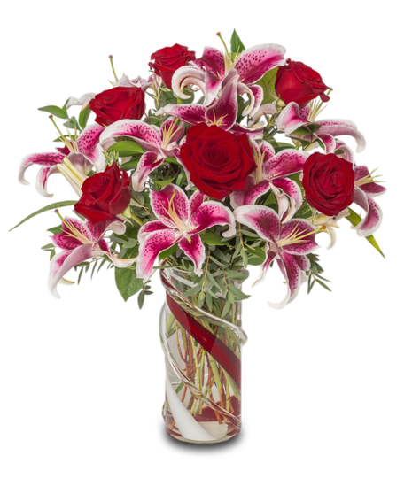 Lovestruck Lilies with Stargazer lilies, eucalyptus, and tropical greens in a red and clear heavy glass vase, designed for all-around viewing. Luxurious and elegant.