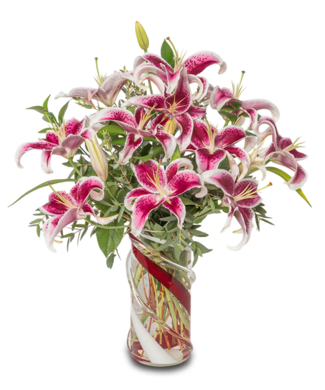 Lovestruck Lilies with Stargazer lilies, eucalyptus, and tropical greens in a red and clear heavy glass vase, designed for all-around viewing. Luxurious and elegant.