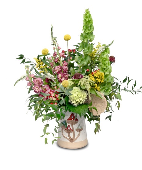 Ceramic mushroom vase with mauve, green, yellow, red, and white flowers in a vegetative style, featuring a dried mushroom sponge accent.