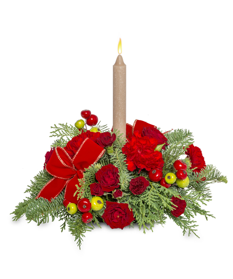 Christmas centerpiece with red roses, red carnations, red and green berries, and velvet ribbon tucks with a candle centerpiece