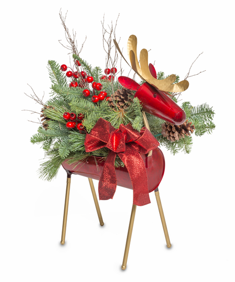 Festive reindeer-shaped holiday centerpiece with evergreen branches, pinecones, red berries, and a red bow