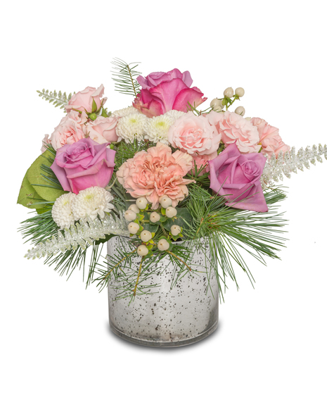 Winter floral arrangement in a silver vase with lavender roses, pink mini roses, white hypericum berries, button chrysanthemums, and frosted ferns