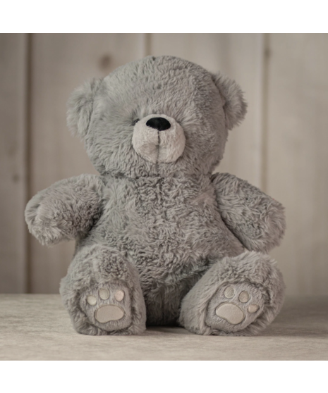 Four plush teddy bears in soft brown, grey, ivory, and light beige sitting on a surface, showcasing different colors of the cuddly Snuggle Bear Collection.